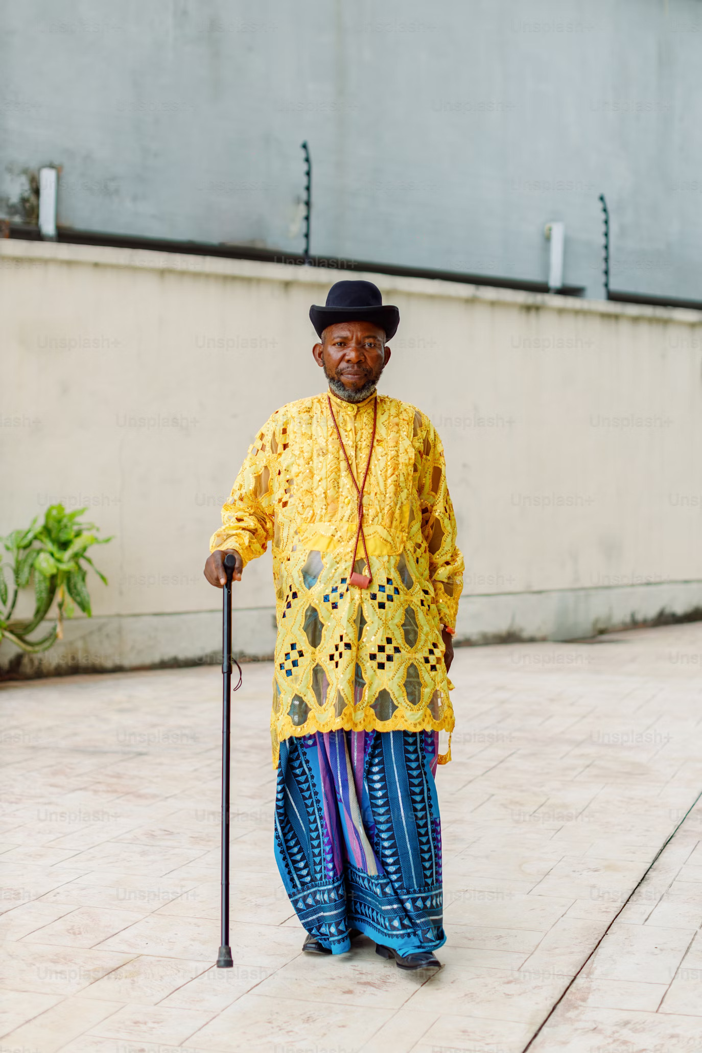 older man wearing bright and 
                                    pleasant top with sarong